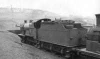 The scrap road at Eastfield shed in January 1962, featuring withdrawn class 2P 4-4-0 no 40566 standing at the end of the line. The locomotive was awaiting transfer to Cowlairs Works for disposal, which took place in October of that year.<br><br>[David Stewart 21/01/1962]
