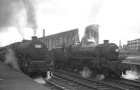 The north end of platform 1 at Carlisle station on 4 July 1964, featuring 45627 <I>Sierra Leone</I> at the head of the 8.50am Blackpool Central - Glasgow Central, standing alongside Black 5 no 45228.<br><br>[K A Gray 04/07/1964]