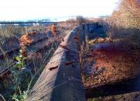 This is the East chord from the Bedford and Peterborough lines to Northampton (formerly Castle) station. In this direction, the bridge crosses the Grand Union Canal, then the River Nene. Goods sidings to the right and left beyond the bridge have gone, as has the West chord. The trackbed from here to Brackmills [see image 34291] has been bought by West Northamptonshire Development Corporation for 1.5m for conversion to a footpath and cycleway.<br><br>[Ken Strachan 21/02/2014]