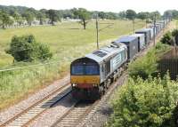 Heading north at Woodacre on a bright July afternoon in 2013 is DRS 66302 with an Anglo-Scottish container train. The loco had originally been operated by Fastline but, along with its stable mates, was snapped up by DRS when Fastline ceased trading.<br><br>[Mark Bartlett 06/07/2013]