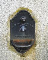 A redundant water fountain in the platform wall of the former Aberlour Station building. The patented water fountain was produced at the Glenfield works of Thomas Kennedy, Kilmarnock, which is still a major manufacturer of large water valves under the <I>Glenfield Valves</I> brand.<br><br>[David Pesterfield 24/06/2013]