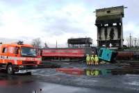 A Lancashire Emergency Services exercise took place at Carnforth on 1st March 2014 using some coaching stock in sidings at the old steam shed, now owned by West Coast Railways. Here a Lancashire fire crew deal with the incident in front of the old coaling tower.   <br><br>[Mark Bartlett 01/03/2014]