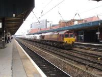 DBS 66170 runs south through Doncaster at 10.00 with a long rake of mixed wagons carrying a large number of mainly 1.5T Peugeot and Citroen badged panel vans, plus a number of chassis cab versions, on a working indicated as originating at Warrington to Doncaster Europort. The empty return working came back through the station at 18.15 the same day.<br><br>[David Pesterfield 28/02/2014]