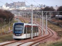 Edinburgh Tram 276 heads towards Balgreen and the city centre on 4 March, passing between Carrickknowe Golf Course and the E & D/Fife main lines.<br><br>[Bill Roberton 04/03/2014]