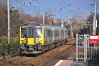 Unit 350404 coasts downhill from Kingsknowe station with the 12.00 TransPennine service from Manchester Airport to Edinburgh Waverley on 4 March 2014.<br><br>[Bill Roberton 04/03/2014]