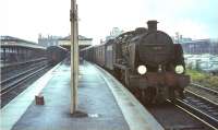 Maunsell U class 2-6-0 no 31809 awaits its departure time from Reading Southern station in the summer of 1964 with a train for Basingstoke. Reading GWR station stands in the right background.   <br><br>[John Robin 24/08/1964]