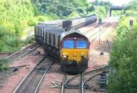 Coal empties returning to Hunterston leave Halbeath sidings in June 2006. EWS 66021 brought in the empties from Longannet power station earlier and has since run round the train, which is now crossing to the up line heading for the Forth Bridge. In the adjacent siding a loaded train has recently arrived on the reverse journey and is waiting for the empties to depart before the locomotive runs round and heads off to Longannet via Charlestown Junction.<br><br>[John Furnevel 13/06/2006]