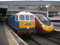 <I>'OK old codger, I'll race you!'</I> The Pendolino seems to be having a quiet word with preserved class 86 no 86259 <I>Les Ross</I> at the head of the <I>Cumbrian Mountain Express</I>, as two generations of WCML power stand side by side at Euston on 8th March 2014.<br><br>[Michael Gibb 08/03/2014]