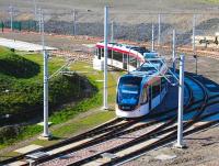 A tram emerges from below the A8 at Gogar on 11 March and swings sharp left towards the site of Edinburgh Gateway tram stop. The tracks to the north lead into Gogar tram depot, now protected by the green gates top left. <br><br>[John Furnevel 11/03/2014]