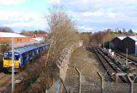 The 15.05 Paisley Canal - Glasgow Central departs through the site of the original Hawkhead station on 10 March 2014. The disused and disconnected oil depot sidings stand on the right.<br><br>[Colin Miller 10/03/2014]