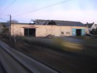 An evening grab shot from a passing train showing the remains of the old roundhouse at 52D Tweedmouth. The east end section of the roof was badly damaged by a fire in January 2010. [See image 40716]<br><br>[David Pesterfield 11/03/2014]
