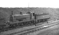 Drummond 2F 0-6-0 no 57359 standing in a line of locomotives awaiting disposal at Hurlford shed in April 1962. The end in this case came in June 1963 in the yard of Messrs Connel of Coatbridge.<br><br>[David Stewart 17/04/1962]