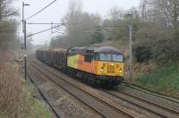 56087 rumbles south on the WCML near Barton and Broughton with the daily Carlise Yard to Chirk logs. On this windless afternoon the Colas Class 56 could be heard powering this heavy train long before it actually appeared, something that doesn't really happen with more modern traction. <br><br>[Mark Bartlett 13/03/2014]