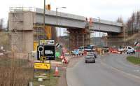 The Borders Railway bridge over Hardengreen roundabout looking north along the A7 on 13 March 2014, approximately a month on from the deck being lifted into position. A Dalek seems to have materialised near the south end of the bridge and is waving to passing motorists.<br><br>[John Furnevel 13/03/2014]