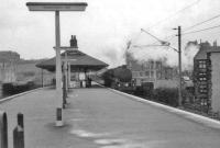 Polmadie Standard class 5 4-6-0 no 73075 runs through Pollokshaws East on a damp and overcast Saturday 11 April 1964 with a football special from Gourock to Kings Park. <br><br>[John Robin 11/04/1964]