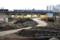 Looking west over the former Partick Central station site in March 2014, with an eastbound emu having just left the modern day Partick Station crossing the viaduct heading for Glasgow city centre. Note the entrance to the tunnel on the right that once took the L&D through to Partick West and beyond. [See image 30966]<br><br>[Colin Miller 19/03/2014]