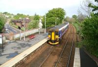 The 09.27 East Kilbride - Glasgow Central DMU pulls way from the platform at Busby after a shower of rain on a May morning in 2007. The train has just crossed the bridge over the A726. <br><br>[John Furnevel 06/05/2007]