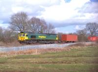 Freightliner 66568 looks a lot greener than the vegetation as it passes Kings Wood recreation ground, approaching Arley tunnel, on a Friday lunchtime in March. I noted three Westbound freights in little more than ten minutes - three more than on my previous lunchtime visit.<br><br>[Ken Strachan 21/03/2014]