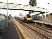 The 1207 Manchester to Bristol CrossCountry Voyager passing Ashchurch for Tewkesbury station on 8 March 2014. The line into the MOD depot is just visible to the right of the footbridge.<br><br>[John McIntyre 08/03/2014]