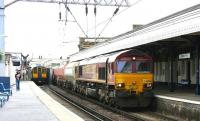 EWS 66086 has just crossed the bridge over the A503 as it brings a westbound freight through Camden Road station on the North London Line in July 2005. On the left a Silverlink dual voltage class 313 emu is pulling away in the opposite direction on a Richmond - North Woolwich service.<br><br>[John Furnevel 21/07/2005]