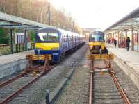 Concourse view over the buffers at Bradford Forster Square on 24 March, with former ScotRail unit 322482 in Platform 3 between duties and 333007 arriving in Platform 2 from Leeds. <br><br>[Mark Bartlett 24/03/2014]