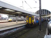 ScotRail 156435 is stabled forward of a Northern 156 unit in the east end down side bay at Newcastle Central, after arrival, via the High Level Bridge, with the 07.08 service from Glasgow Central. Meantime East Coast 91132 waits at platform 4 during its 45 minute layover prior to returning to London at 12.25.   <br><br>[David Pesterfield 28/02/2014]