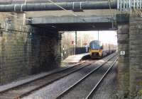 Prior to closure in 1965 Frizinghall's platforms were situated opposite each other but when it reopened in 1987 they were staggered either side of the road overbridge. This view looking south from the northbound platform shows 333011 calling at the station heading towards Bradford Forster Square. Perhaps the station's main claim to fame is that its signalbox lives on at Damens loop on the KWVR. <br><br>[Mark Bartlett 24/03/2014]