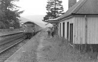 A pair of class 26s bring a train south through the closed Dalnaspidal station in 1975. The building was later moved to the Strathspey Railway's Speyside station at Aviemore.<br><br>[Bill Roberton //1975]