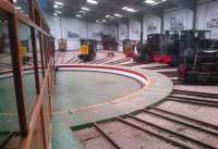 <I>The Grain Store</I>, on the Statfold Barn Railway, may not sound like an exciting location, but it contains a splendid collection of narrow gauge engines, mostly beautifully restored and powered by steam. A BLS special train edges across the turntable on 30th March 2014. Notice that some roads have dual gauge track.<br><br>[Ken Strachan 30/03/2014]