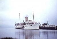 PS <I>Maid of the Loch</I> alongside Balloch Pier on 24 August 1965. Note the catenary on the Pier and the oil tank. Balloch Pier station closed in September 1986. [See image 16428]<br><br>[G W Robin 24/08/1965]