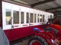 A GNSR third class and luggage composite coach body in a small shed outside the main exhibits at Statfold Barn on 30 March 2014 [see image 46824]. Notice the vintage tractor to the right.<br><br>[Ken Strachan 30/03/2014]