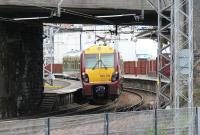 A Helensburgh - Airdrie service runs east under Gartsherrie Road bridge and into Coatbridge Sunnyside station in May 2005. The line immediately beyond the metal fence running off to the right is the single line freight only link between Sunnyside Junction and Whifflet South Junction [see image 22309].<br><br>[John Furnevel 09/05/2005]