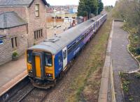 A Preston to Ormskirk service at Croston on 5 April. The service is usually a single Class 153 or a Class 142 unit but on the day of the Grand National at Aintree, Northern supplemented 153317 with 150111. The disused platform on the right has received quite a makeover by the Friends of Croston Station [see image 36136].<br><br>[John McIntyre 05/04/2014]