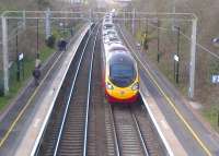 An up Pendolino passes through Canley, in the south western suburbs  of Coventry, on 21 March 2014 [see image 46744 for the view in the opposite direction].<br><br>[Ken Strachan 21/03/2014]