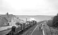 Black 5 44767 heading north through Stobs station on 11 April 1967 hauling diesel shunters D2608, D2617 and D2593, on their way from Bradford Hammerton Street to Haymarket shed. The photographer on the platform is Douglas Walker; [see image 46980] for his photograph of the procession.<br><br>[Bruce McCartney 11/04/1967]