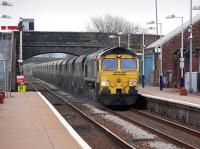 Freightliner Heavyhaul 66548 powers through New Cumnock with coal hoppers on 31 March 2014.<br><br>[Bill Roberton 31/03/2014]