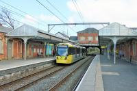 Like their counterparts on the Bury line many of the Metrolink stations on the Altrincham line retain the features from their main line railway days. This is Sale in April 2014, complete with canopies and street level booking hall, as Tram 3012 calls on its way to Manchester. <br><br>[Mark Bartlett 14/04/2014]