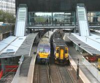 The 12.41 Edinburgh - Milngavie meets the 11.18 Glasgow Central - Edinburgh at Haymarket station. View west over platforms 3 and 4 on 11 April 2014 with works nearing completion.<br><br>[John Furnevel 11/04/2014]