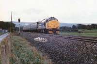 The heady days of loco-hauled trains along the Welsh Marches came to a halt in the late eighties. A southbound large logo class 37 passes the site of Ponthir station in September 1988, some 26 years after closure. The upper reaches of the town of Cwmbran  can be seen in the right background. [Ref query 5624]<br>
<br><br>[Ken Strachan /09/1988]