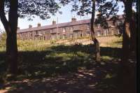 Surviving dwelling houses in the railway village at Riccarton Junction in Spring 1966. In 1949-50 all 33 railway houses and the School House had been occupied, but by the time of this photo - two years after the school closed and a year after the Co-op shut its store on the station platform - just a dozen houses remained in occupation. The closure proposal for the Waverley Route came in August 1966 and by the following year a further third of the houses had been abandoned. The writing was on the wall for Riccarton.<br><br>[Frank Spaven Collection (Courtesy David Spaven) //1966]