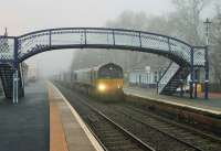 Inverness bound Tesco containers rolling north through Pitlochry behind 66430 early on a misty morning in April 2014. <br><br>[Mark Bartlett 05/04/2014]