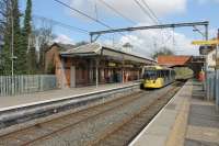 Metrolink 3051 leaves Brooklands on a Manchester bound service, next stop Sale, which is just visible through the bridge arch. The Bridgwater Canal lies immediately behind the Up platform and runs parallel to the line. [See image 41430] for the same station in 25kv main line days.  <br><br>[Mark Bartlett 14/04/2014]