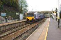 A Liverpool Lime Street to Manchester Victoria service calls at Lea Green on 19 April 2014. Work associated with the forthcoming electrification can be seen to the right of the station sign and in the distance under the bridge.<br><br>[John McIntyre 19/04/2014]