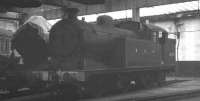 Earmarked for preservation. Class N7 0-6-2T no 69621 of 1924, withdrawn from Stratford shed in November 1962, photographed inside Neville Hill in March 1965. [See image 33828]. The N7 is standing alongside another notable preserved locomotive, no 3442 <I>The Great Marquess</I>. [Ref query 6628]<br><br>[K A Gray 21/03/1965]