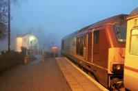 The northbound Caledonian Sleeper service pulls away from Pitlochry at 0617 on 5 April, next stop Blair Atholl. Beyond DBS 67004 the signal box can be seen through the early morning mist.  <br><br>[Mark Bartlett 05/04/2014]