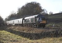 EE Type 3 No. 37075 rolls downhill midway between Oxenhope and Haworth with a morning KWVR <I>Santa Special</I> on 30th November 2013. The train is tailed by Black 5 N0. 45305, the presence of which is only betrayed by leaks from the steam heating connections.<br><br>[Bill Jamieson 30/11/2013]