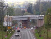 The new Borders Railway bridge over Hardengreen roundabout looking south on 27 April 2014. Side panels are now in place along both sides of the deck and much of the scaffolding has been removed. Newbattle viaduct stands in the background, complete with temporary safety fencing.<br><br>[John Furnevel 27/04/2014]