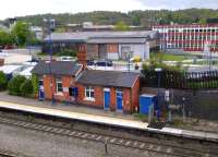 Looking South to High Wycombe town in April 2014, the outbuildings and gable end of the third and current (1906) station can be clearly seen. The building in the background is less well known. The near section with roller doors was an engine shed - more recently a car tyre fitting centre - while the larger building beyond it was the original 1846 train shed, used until 1864. The station entrance and offices are hidden behind the train shed, which is listed Grade 2.<br><br>[Ken Strachan 26/04/2014]