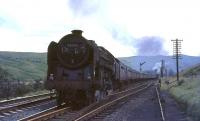 Clan Pacific no 72008 <I>Clan MacLeod</I> passing Greskine on 31 July 1965 with the summer Saturday Blackpool North - Dundee. At the rear of the train is Beattock shed's Fairburn 2-6-4T no 42693. The Pacific had taken over the train at Carlisle [see image 46497].<br><br>[John Robin 31/07/1965]