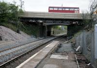 A 'golden eagle' crosses the temporary bridge at Bargeddie station on 28th April 2014. The new A752 road bridge over the line currently under construction can be seen just beyond. Electrification of the Whifflet branch is due to be completed by the end of this year.<br><br>[Colin McDonald 28/04/2014]